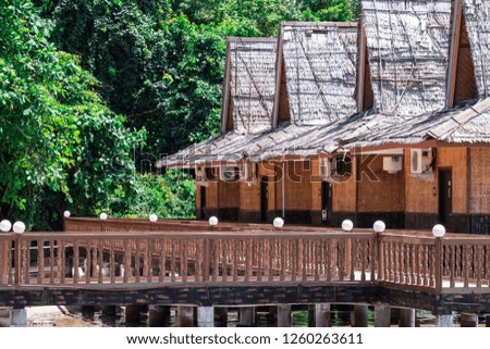Beach resort with nipa hut cottages and forest during the hot summer day