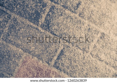 Snow on stones of a paving slabs. New year and christmas theme. Toned.