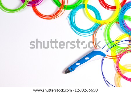 3d pen with colourful plastic filament on white background