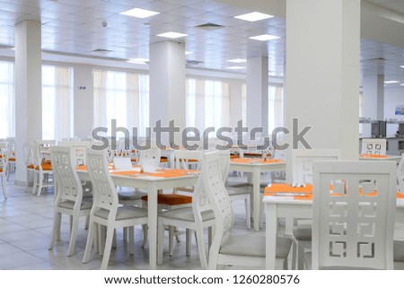 Bright white cafe interior with orange details 1