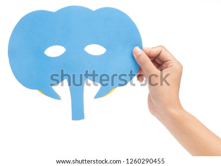 hand holding elephant carnival mask isolated on white background