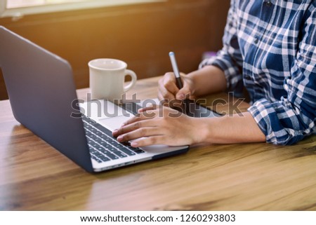 Close up shot hands of freelancer use laptop working on desk of her this is a lifestyle of freelance or editor.