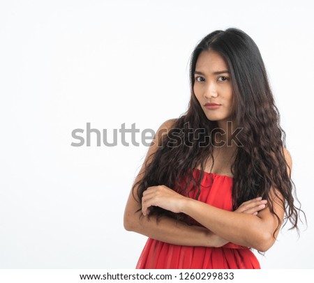 Beautiful young woman in red dress put hands covering her mouth as secret sign concept, portrait shot isolated on white background.