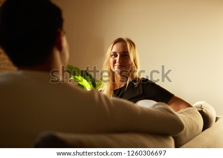 Conversation of attractive man and young blond woman at home. Family at home.