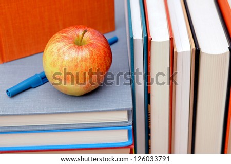 books, pen and apple for education decoration
