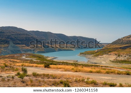 Picture of blue lake between mountains in the desert