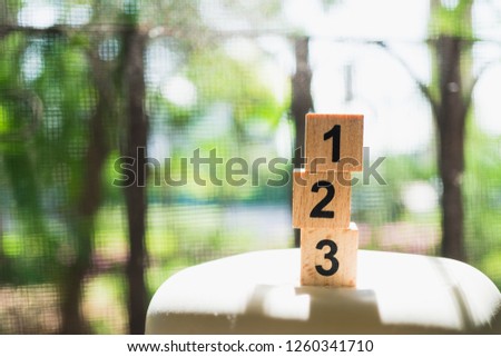 Wooden number on sunlight using as business and competition concept