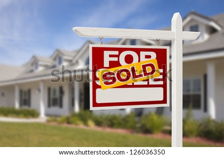 For Sale Sold Real Estate Sign and New House.