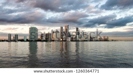 Downtown Miami captured at sunset from a beautiful bay that borders the city, the view shows all the skyscrapers as a sign of the magic and progress of the city of the sun.