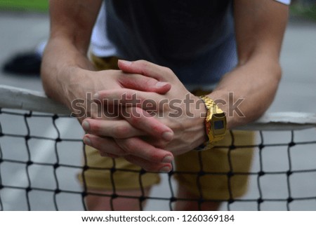 men hands with wrist watch in the tennis court