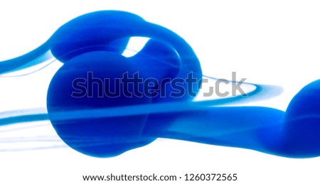 Abstract pattern falling into the water drop of blue ink