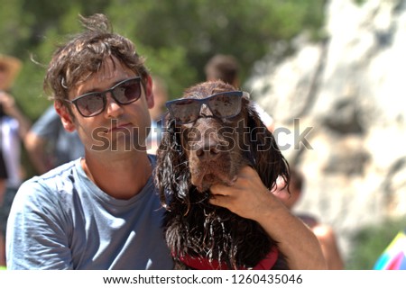 The owner of the dog and the dog are very similar to each other. Sit hugging. Royalty-Free Stock Photo #1260435046