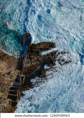 Aerial view of waves crashing against the coastline. Seascape panorama taking with a Drone.