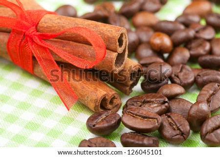 cinnamon sticks with red ribbon and coffee beans
