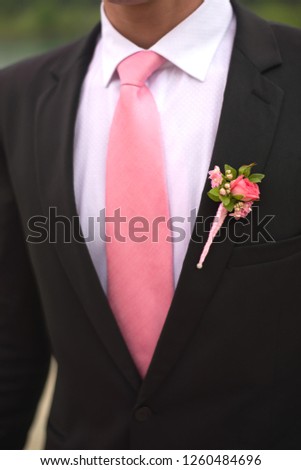 Stylish groom suit closeup with boutonniere