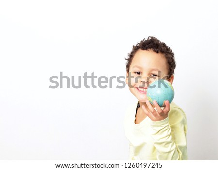 boy and globe on earth day smiling with white background stock photo