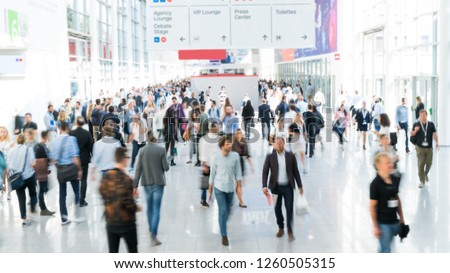 blurred business people at a trade fair Royalty-Free Stock Photo #1260505315