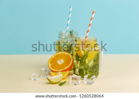 Citrus lemonade water with lemon sliced , healthy and detox water drink in summer on light-blue background