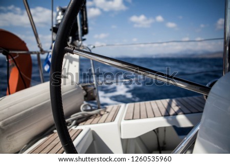 View through the boat's sheering wheel in the sea in Greece