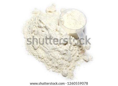 heap of protein powder with plastic spoon on white background Royalty-Free Stock Photo #1260559078