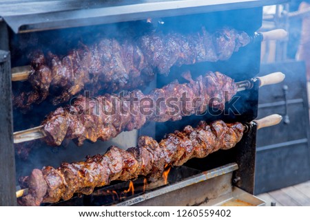 Traditional european grilled meat with smoke on Christmas fair