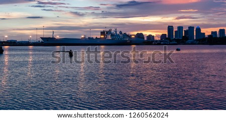 purple pink sunset with a big ship and Tampa skyline in the background 
