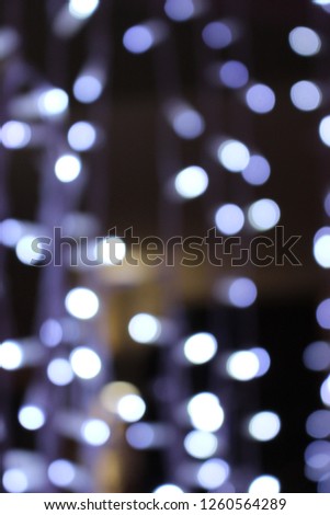 Dark background at night with white and blue lights