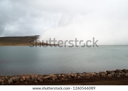 Fog edge moving over small lake near the road between Egilsstadir and Seydisfjordur. 