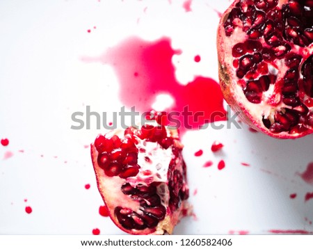 top view of pomegranate with juice on white background