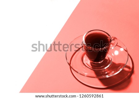 Trend photography on the theme of the actual colors for this season - a shade of orange. Cup of coffee on a bright background color fuchsia photo from above.