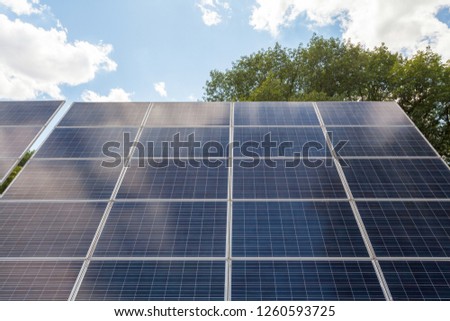 Low angle top view close up photo of solar battery panel or new solar power equipment against blue beautiful sky