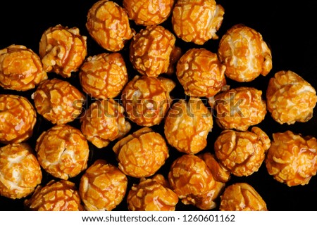 sweet Caramel Cream popcorn on the black background. Close-up picture, macro details