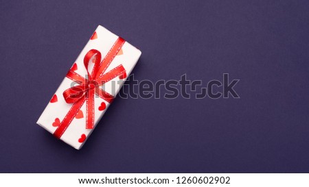 gift wrapped in a red box with a picture of a heart for Valentine's Day. Isolate on white background with shadow