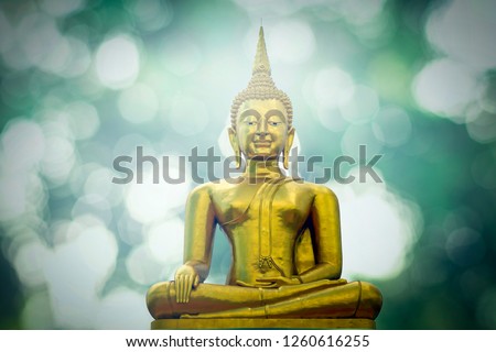 Buddha status on green bokeh background
