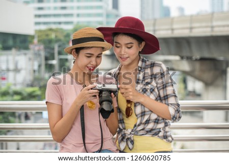 Tourist girl Viewing photos from a camera on BTS station.