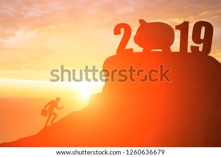 silhouette of business man run to 2019 with piggy bank on the mountain