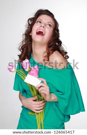 Studio image of fashion beautiful young woman with pretty pink tulips on Holiday theme