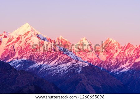 Panoramic view during sunset over snow cladded Panchchuli peaks falls in great Himalayan mountain range from Khalia top trekk trail at small hamlet Munsiyari, Kumaon region, Uttarakhand, India. Royalty-Free Stock Photo #1260655096
