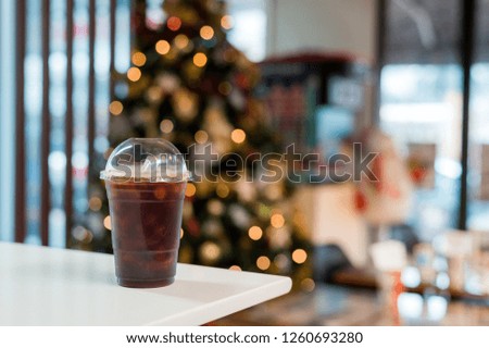 ice black coffee and splash bokeh lighting in christmas holidays