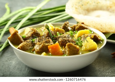 Traditional Kerala foods- meat stew served with appam.