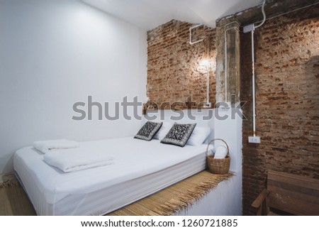 A private bedroom of a hostel  decorated with beautiful brick wall makes traveler feel comfy and cozy