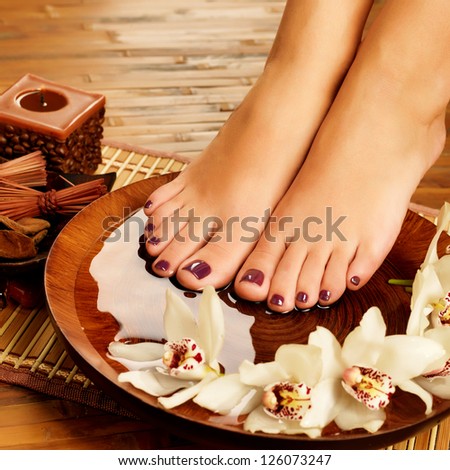 Closeup photo of a female feet at spa salon on pedicure procedure. Legs care concept