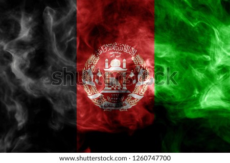 National flag of Afghanistan from thick colored smoke on a black isolated background 