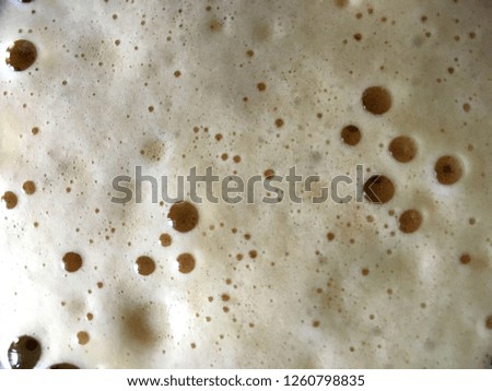 Carbonated drink foam close up with small bubbles texture