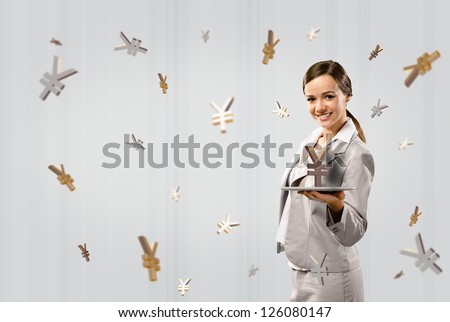 attractive business woman holding a tablet with sign yen, financial concept