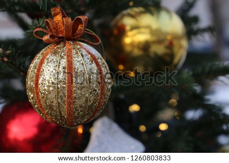 Christmas balls on fir branches in winter night. New Year decorations and festive lights, christmas toys, magic of the holiday