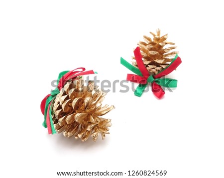 Golden pine cones with ribbon bow for Christmas decoration isolated on white background