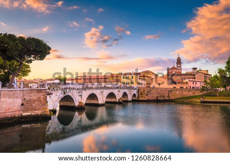 Rimini cityscape. Tiberius bridge famous sightseeing in Rimini at dawn. Summer sunrise in Rimini historic center. Royalty-Free Stock Photo #1260828664