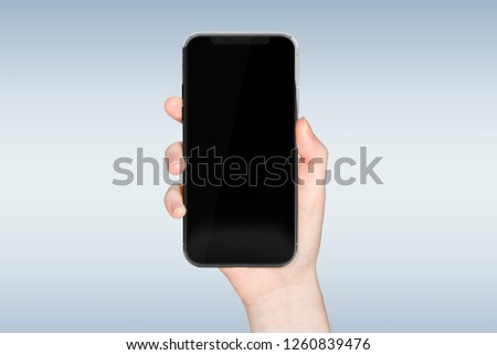 Woman hand holding modern smatphone mockup on grey background