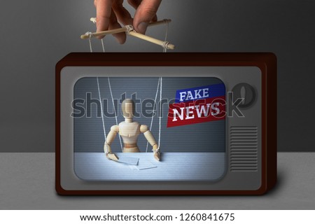 Fake News on TV. The correspondent as the doll controls the puppeteer. Lying information to trick people on TV. Royalty-Free Stock Photo #1260841675